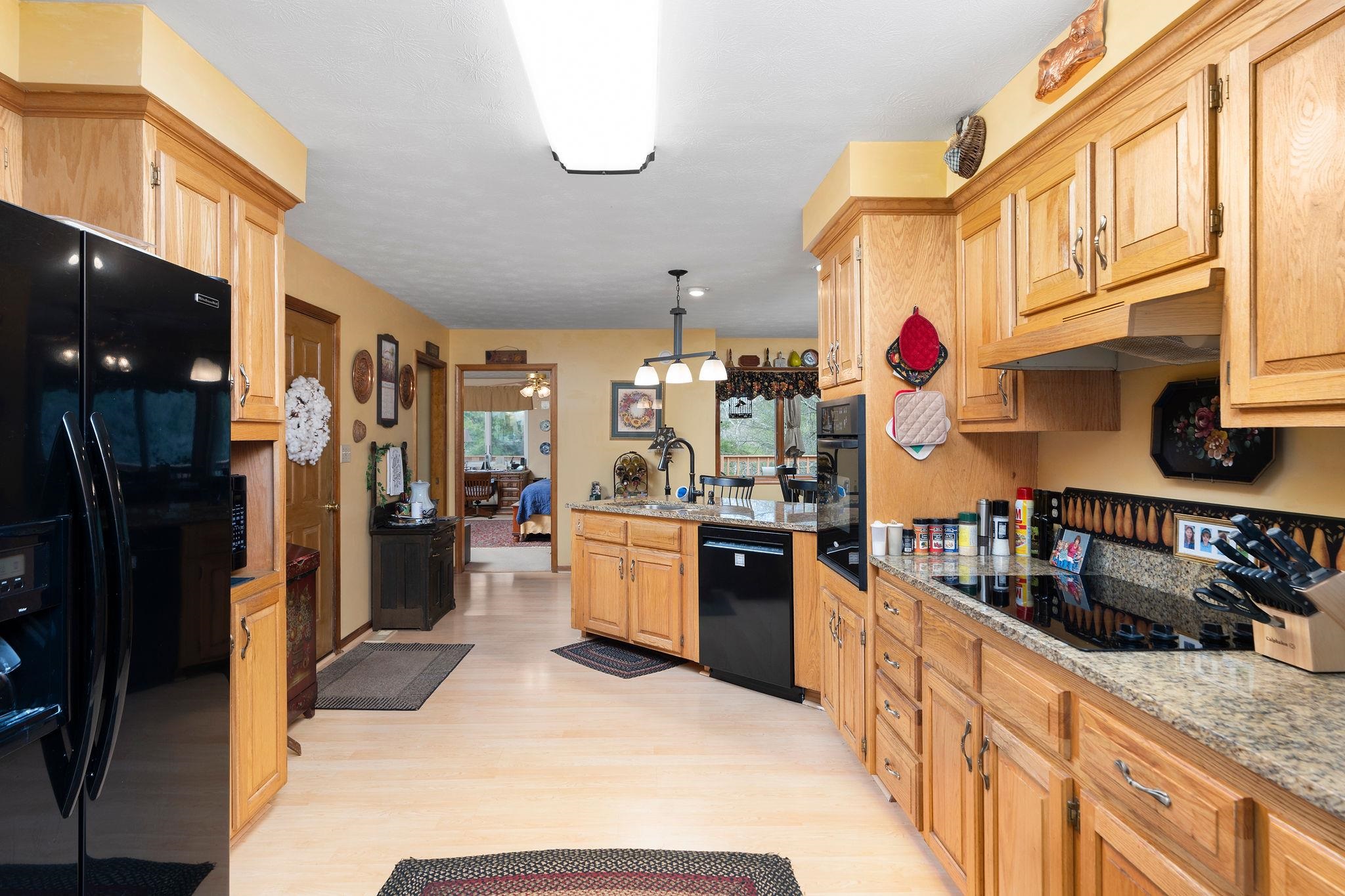 53 Fort River Road Verona, VA 24482 - Photo 20 of 75 a kitchen with granite countertop lots of stainless steel appliances granite countertop lots of counter top space and wooden floor