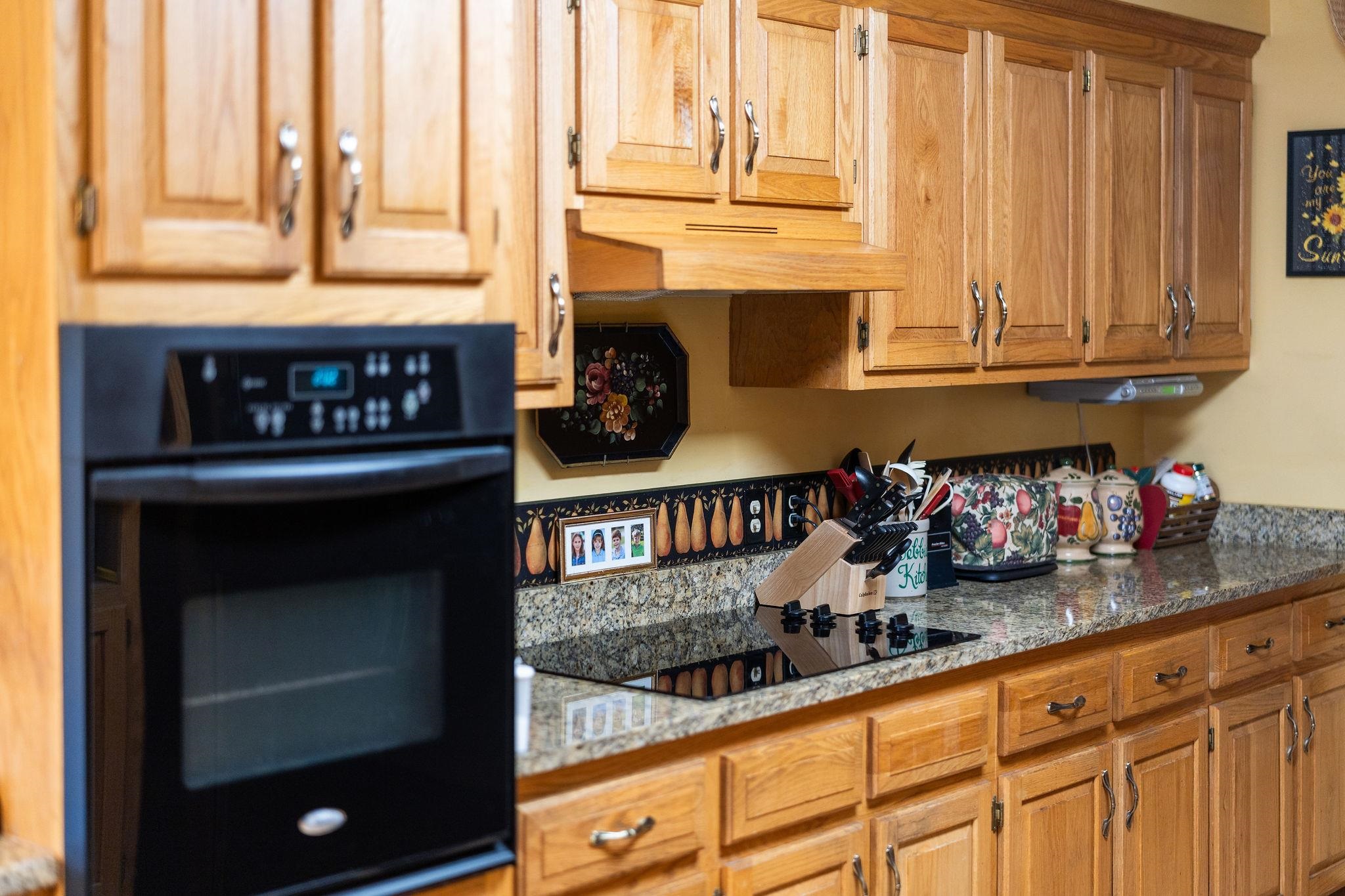 53 Fort River Road Verona, VA 24482 - Photo 21 of 75 a kitchen with granite countertop a stove a sink and a cabinets