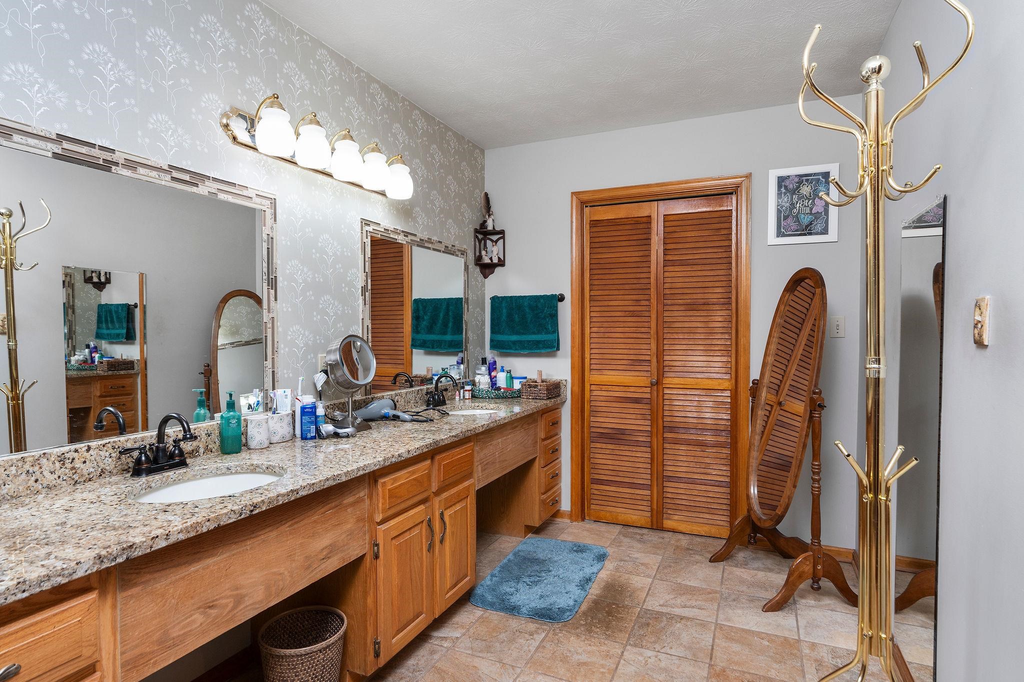 53 Fort River Road Verona, VA 24482 - Photo 26 of 75 a bathroom with a double vanity sink a mirror and a shower