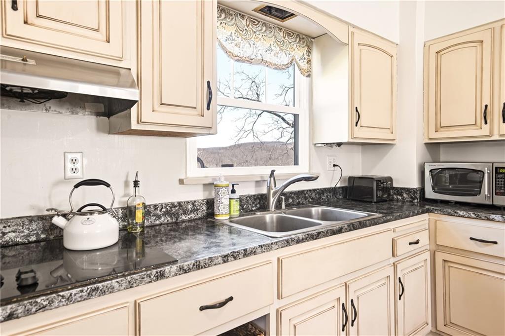2237 Ridgeview Road Mount Pleasant, PA 15666 - Photo 15 of 39 a kitchen with granite countertop a sink a stove and cabinets