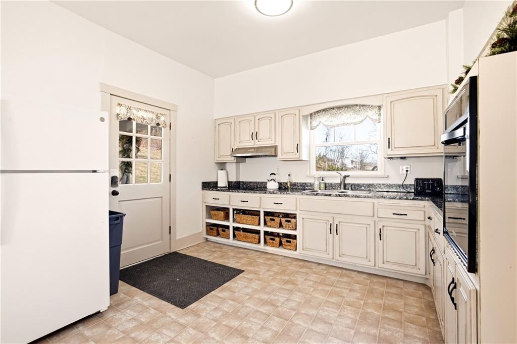 2237 Ridgeview Road Mount Pleasant, PA 15666 - Photo 16 of 39 a kitchen with granite countertop a refrigerator stove top oven and sink