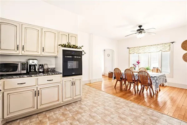 a kitchen with white cabinets and sink