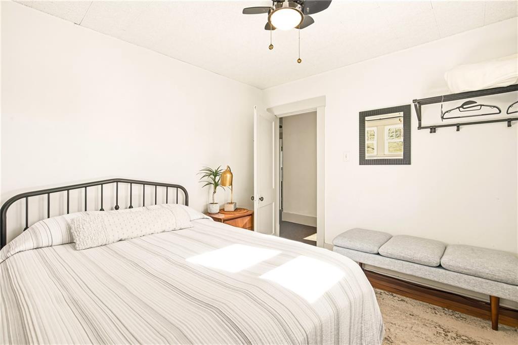 2237 Ridgeview Road Mount Pleasant, PA 15666 - Photo 19 of 39 a bedroom with a large bed and a chandelier