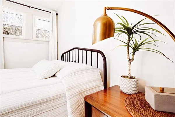 a bedroom with a bed and the view of wooden floor