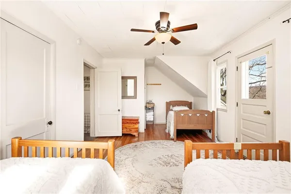 a bedroom with a bed couch and a window