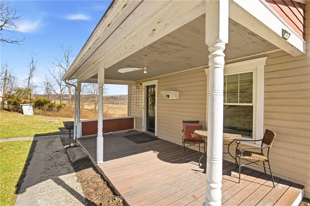 2237 Ridgeview Road Mount Pleasant, PA 15666 - Photo 29 of 39 a view of a patio with table and chairs with wooden floor and fence