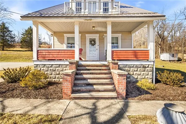 a front view of a house with a large window
