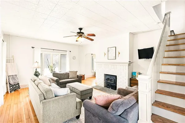 a living room with furniture a fireplace and a flat screen tv