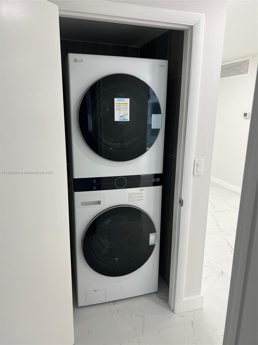 9801 Collins Avenue, Unit 15X/COMPLETE Bal Harbour, FL 33154 - Photo 20 of 24 a close up view of a washer and dryer