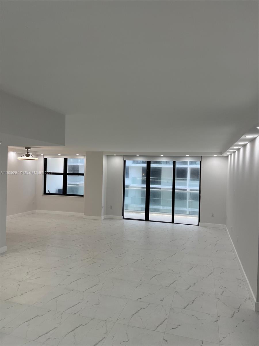9801 Collins Avenue, Unit 15X/COMPLETE Bal Harbour, FL 33154 - Photo 2 of 24 an empty room with windows