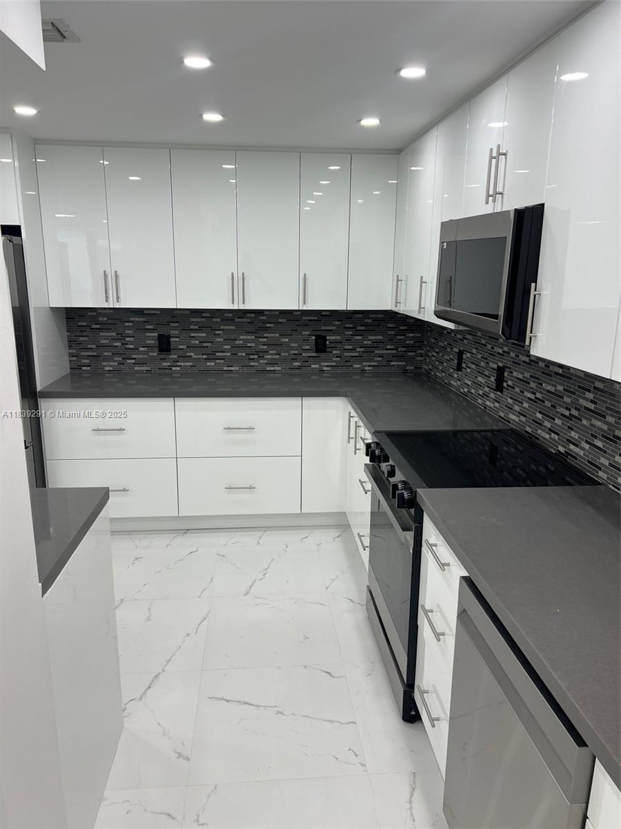 9801 Collins Avenue, Unit 15X/COMPLETE Bal Harbour, FL 33154 - Photo 3 of 24 a kitchen with a sink and cabinets