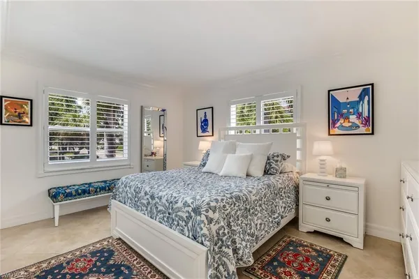 a bedroom with a bed dresser and a window