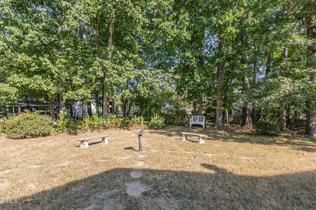 a bathroom with a bathtub a double vanity sink a window a mirror and a shower