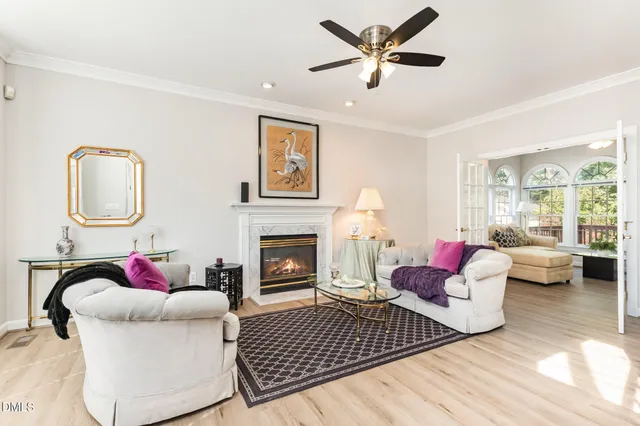a living room with furniture and a large window with garden view