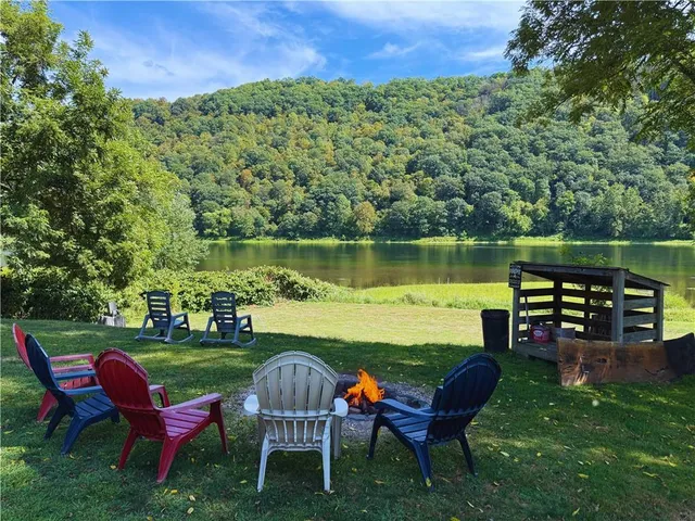 a swimming pool with lawn chairs and a yard