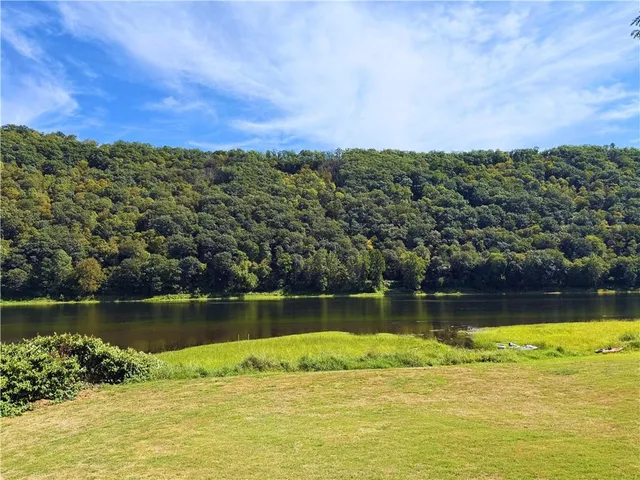 a view of a lake with houses in the back