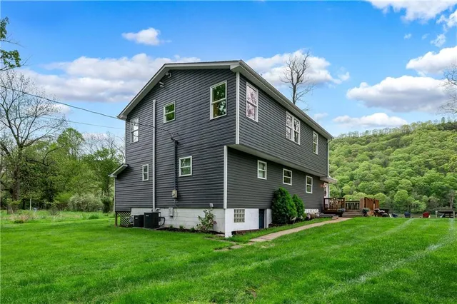 a front view of a house with a garden
