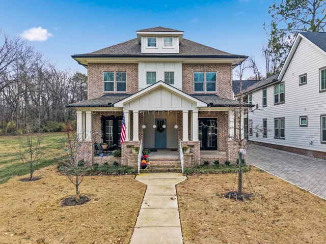 a view of a house with backyard porch and sitting area