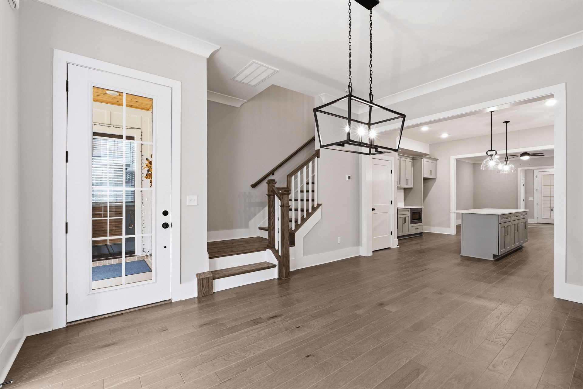 207 Fairground Street, Unit 102 Franklin, TN 37064 - Photo 9 of 70 a view of a livingroom with wooden floor stairs and a chandelier