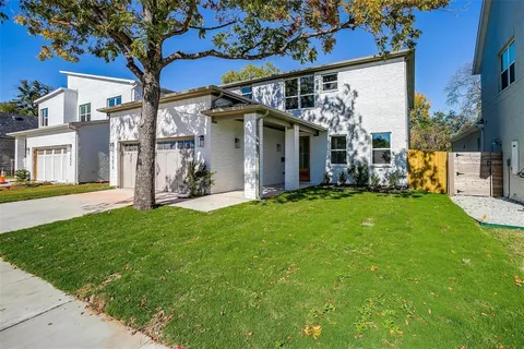 a view of a house with a yard porch and a tree