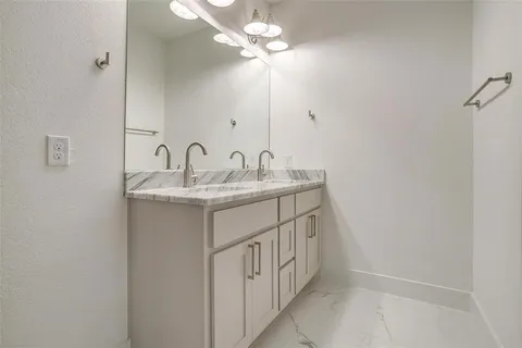 a bathroom with a sink a vanity and a mirror