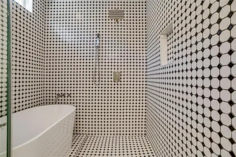 a bathroom with a bathtub and shower