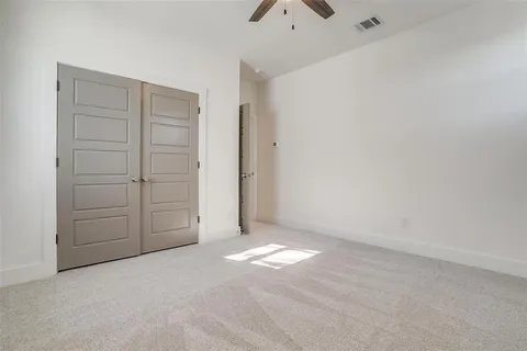 an empty room with closet area