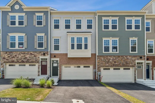 a front view of a building with a garden