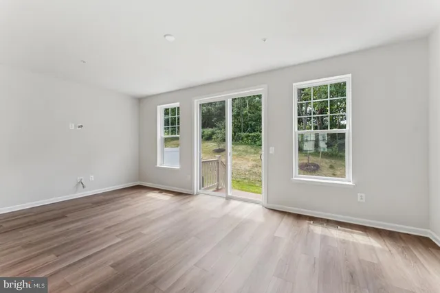 a view of a kitchen with wooden floor and electronic appliances