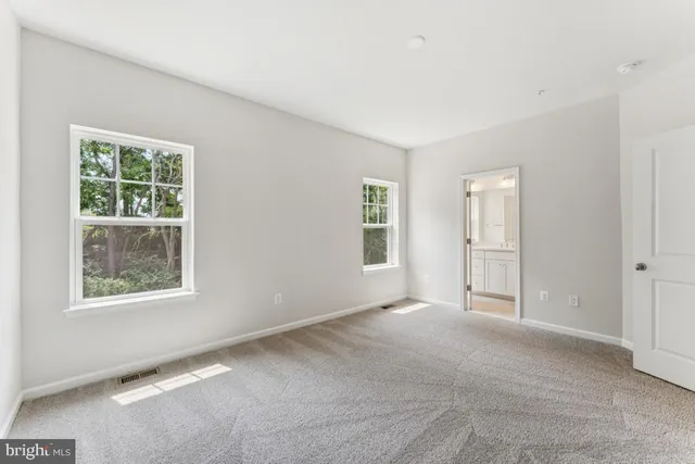 a bathroom with a shower sink vanity mirror and toilet