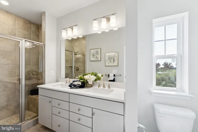 a bathroom with a sink a large mirror and a shower