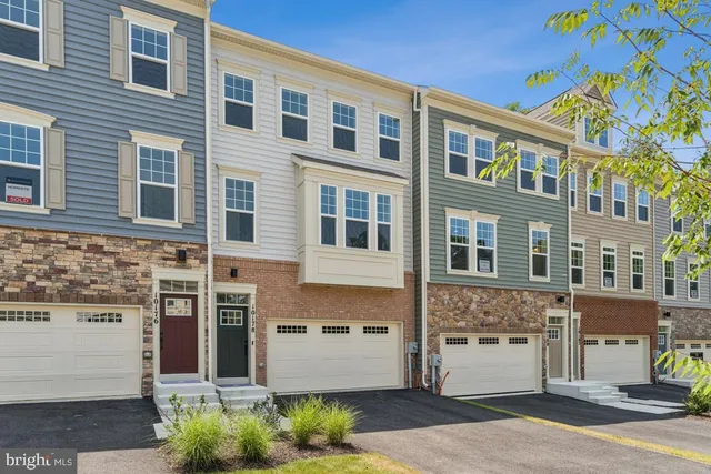 a front view of a building with a garden
