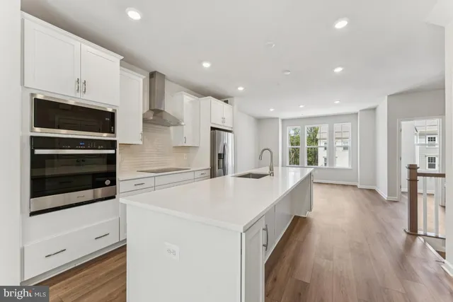 a large white kitchen with a lot of counter space