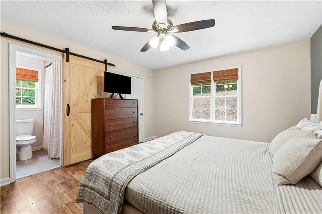 a bedroom with a bed and a television