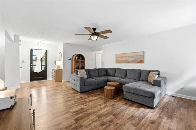 a living room with furniture and a wooden floor