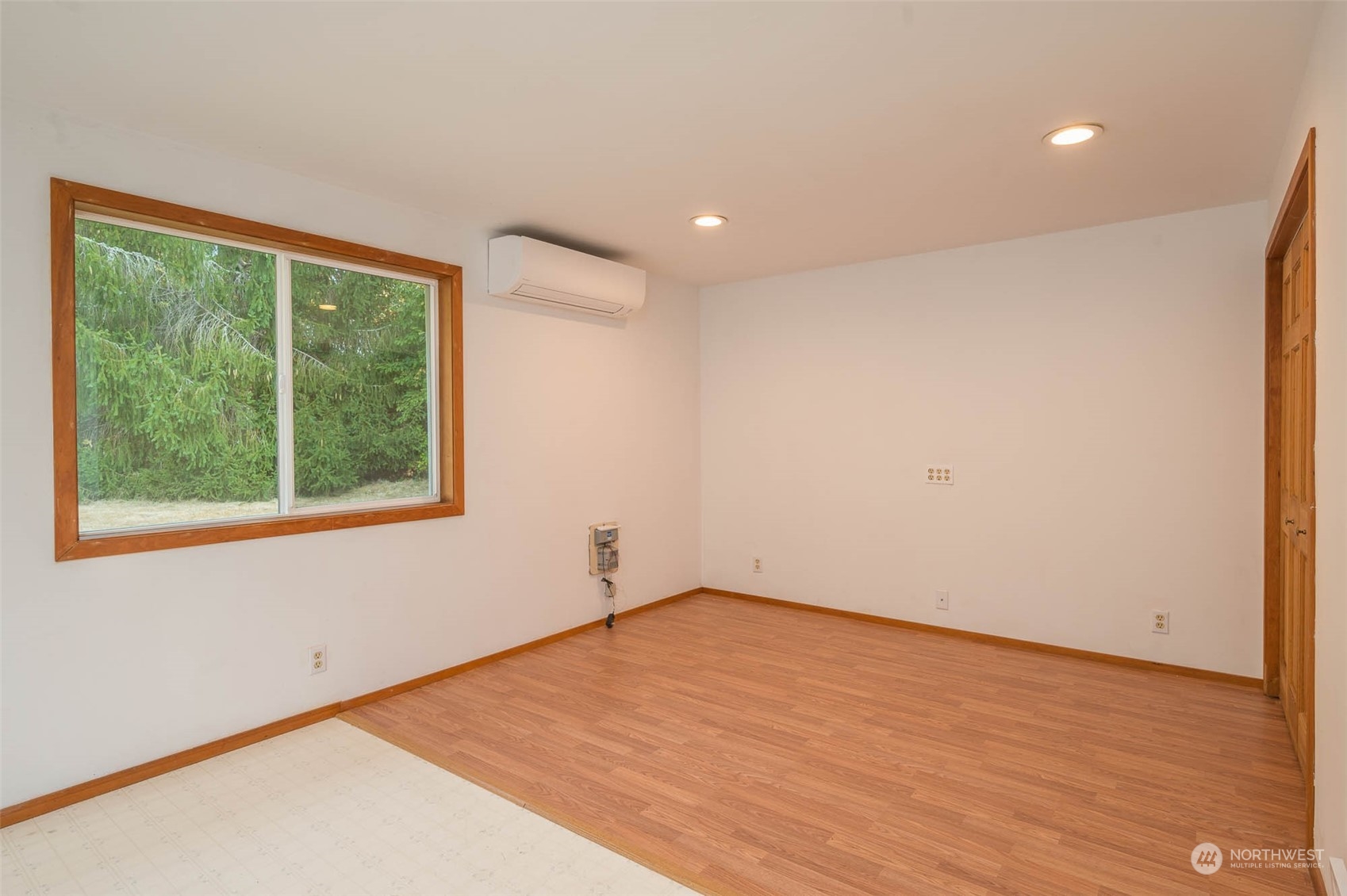 10530 Southwest Cove Road Vashon, WA 98070 - Photo 15 of 34 a view of an empty room with wooden floor and a window