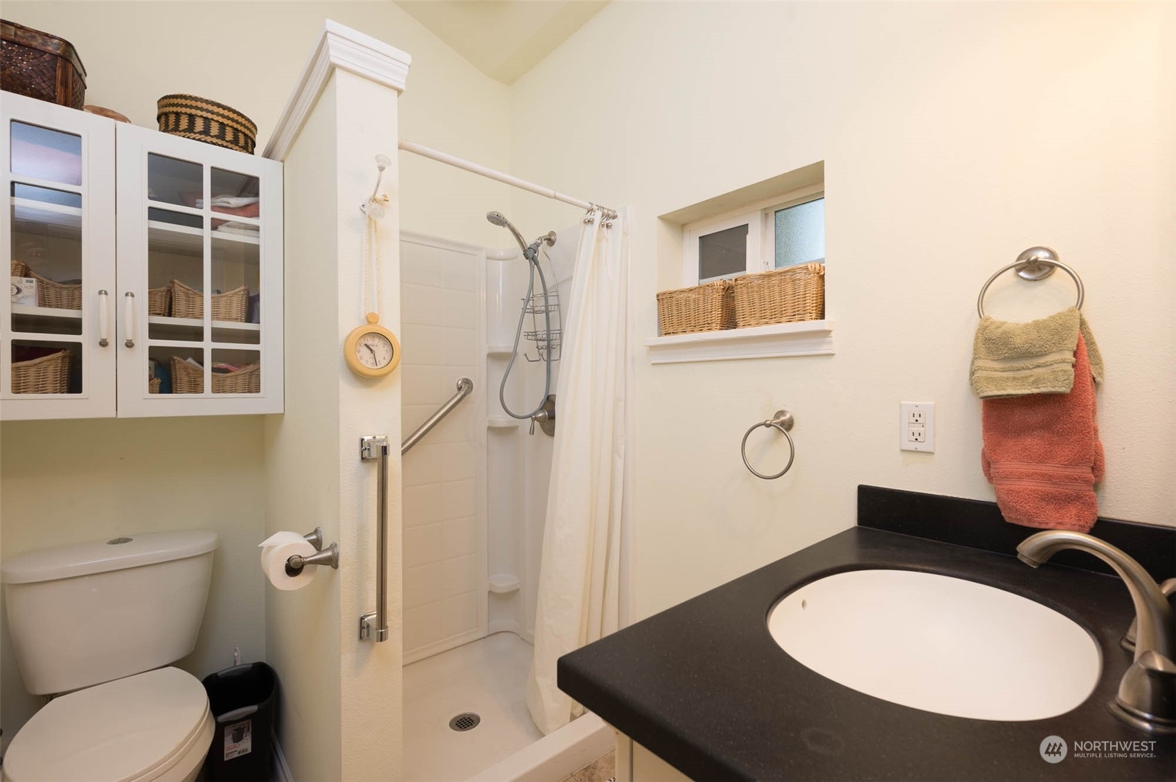 10530 Southwest Cove Road Vashon, WA 98070 - Photo 29 of 34 a bathroom with a sink toilet mirror and shower