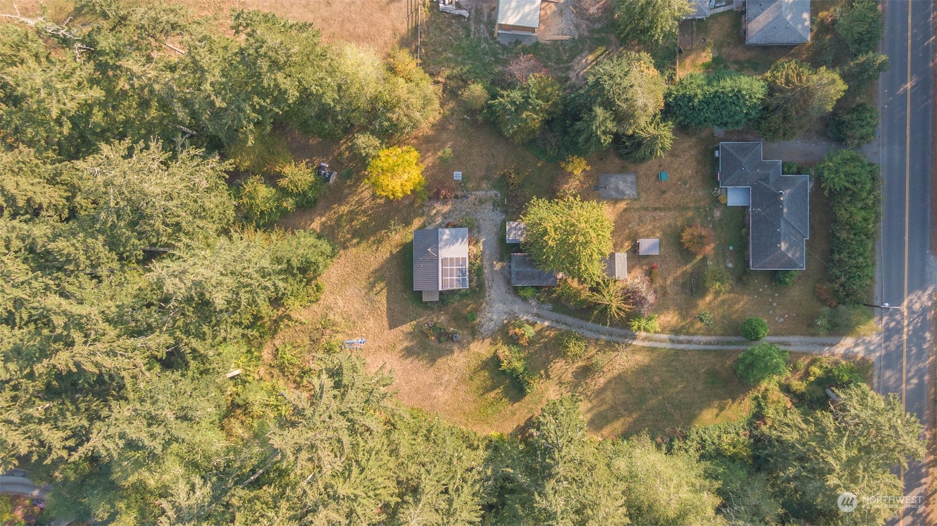 10530 Southwest Cove Road Vashon, WA 98070 - Photo 32 of 34 a backyard of a house with large trees
