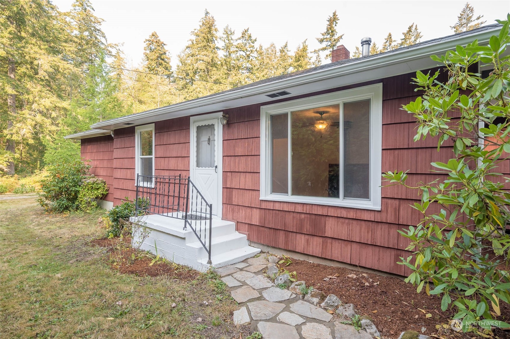 10530 Southwest Cove Road Vashon, WA 98070 - Photo 34 of 34 a view of a house with a small yard and wooden floor and fence
