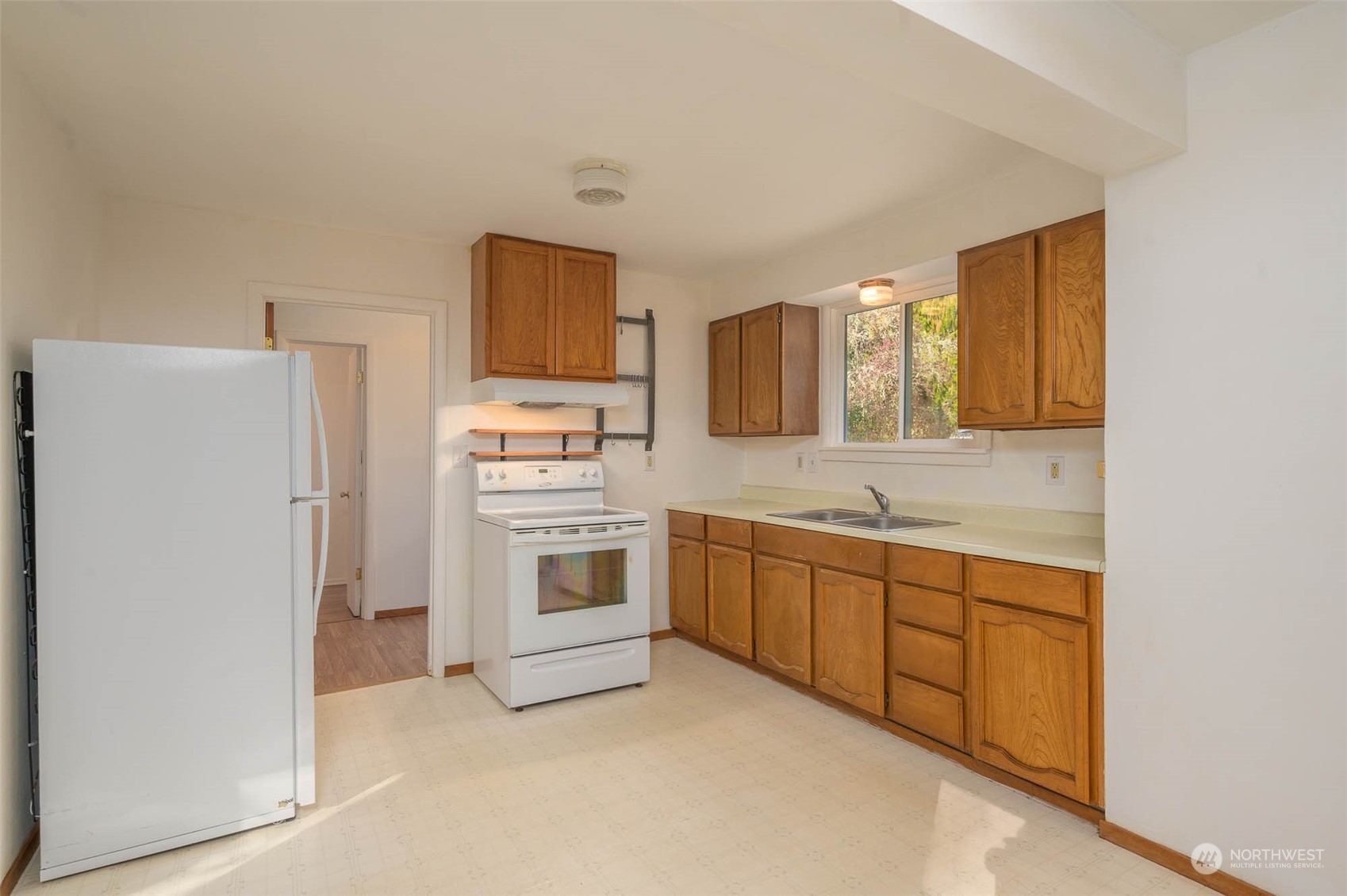 10530 Southwest Cove Road Vashon, WA 98070 - Photo 5 of 34 a kitchen with white cabinets and white appliances