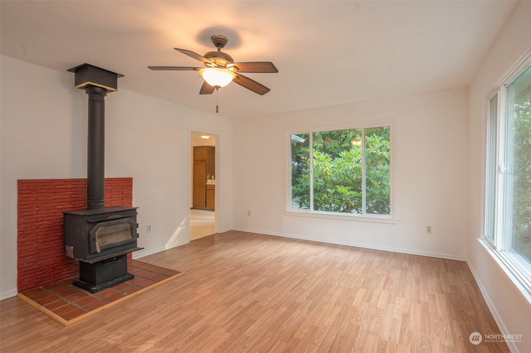 10530 Southwest Cove Road Vashon, WA 98070 - Photo 7 of 34 a view of an empty room with wooden floor and a window