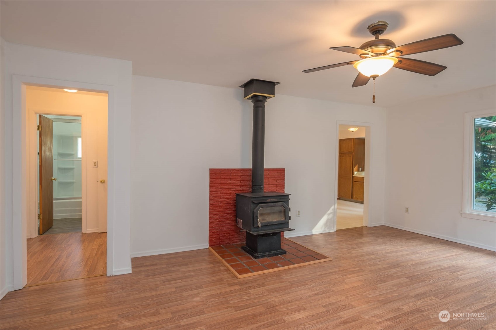 10530 Southwest Cove Road Vashon, WA 98070 - Photo 8 of 34 a view of an empty room with chandelier fan and wooden floor
