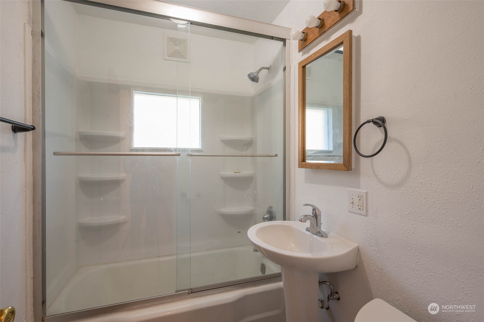 10530 Southwest Cove Road Vashon, WA 98070 - Photo 10 of 34 a bathroom with a sink a toilet and shower