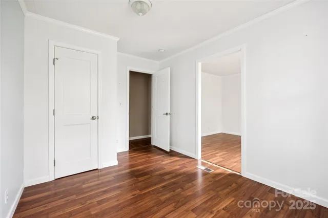 an empty room with wooden floor