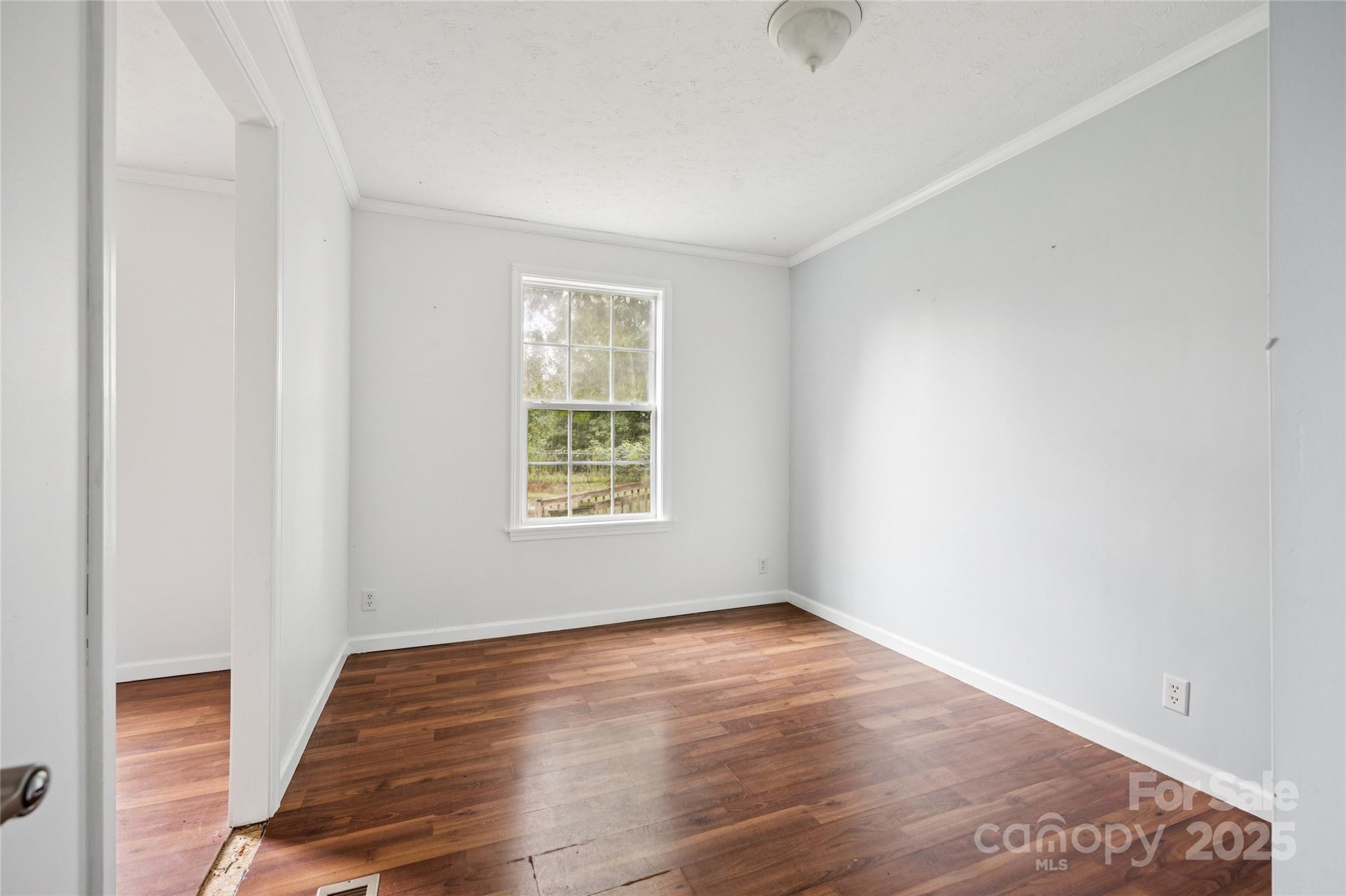 4066 General Howe Road Riegelwood, NC 28456 - Photo 18 of 27 an empty room with wooden floor and windows