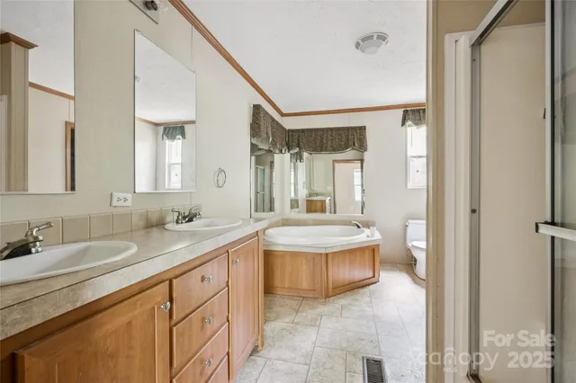 a spacious bathroom with a granite countertop sink a toilet and a mirror