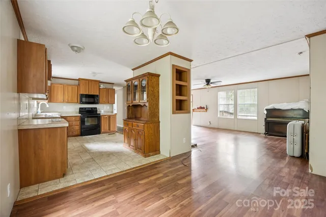 a view of a kitchen with a sink dishwasher stove and refrigerator with wooden floor