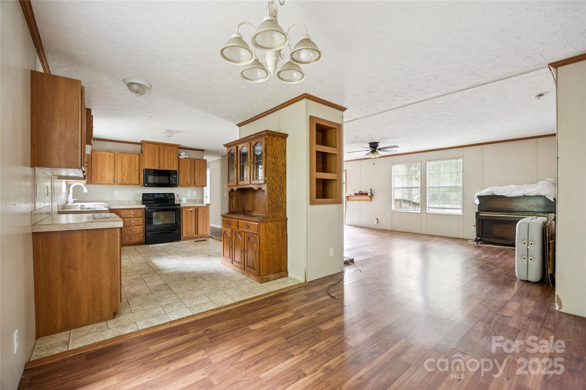 4066 General Howe Road Riegelwood, NC 28456 - Photo 8 of 27 a view of a kitchen with a sink dishwasher stove and refrigerator with wooden floor