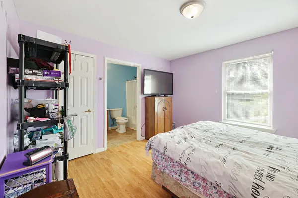 a bedroom with a bed and a dresser