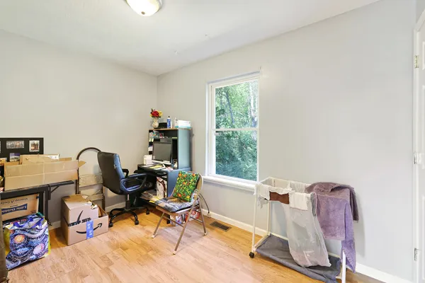 a view of a workspace with furniture and a mirror